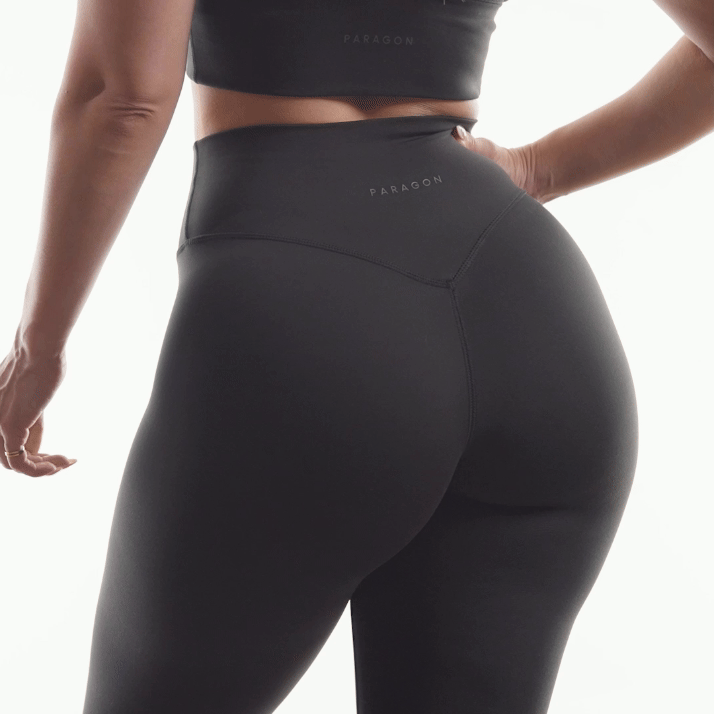 Person wearing black Paragon athletic leggings from the back.